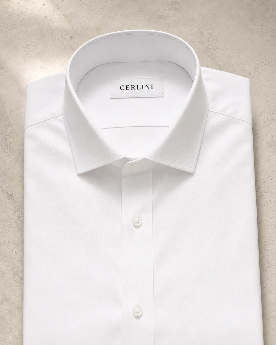 The Partner in white, a Cerlini business shirt folded to show its collar and placket.